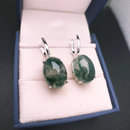 Green stone earrings in a jewelry box