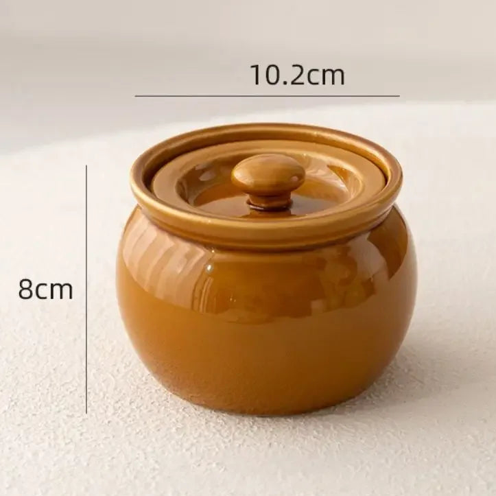 Brown ceramic jar with lid on a white background, showing dimensions.