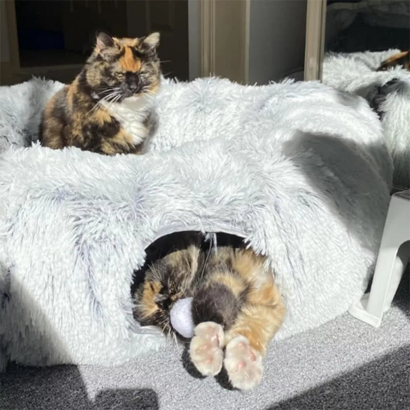 Indulge your feline friend with our Fluffy Donut Cat Bed featuring a cozy tunnel for ultimate comfort. Let your cat cuddle up in the soft and fluffy material, providing a sense of security and warmth. Perfect for those lazy days or a restful slumber. Pamper your cat with this delightful bed!