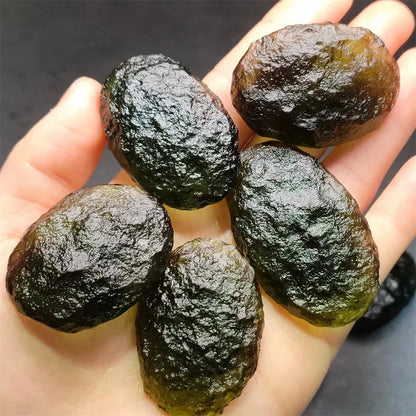 As an expert in the crystal industry, we present to you the Natural Rough Cut Green Moldavite Energy Crystal. Sourced from the Czech Republic, this crystal is known for its powerful energy and potential to enhance mental clarity and spiritual growth. Each crystal is unique with natural rough cuts, making it a one-of-a-kind addition to any collection.