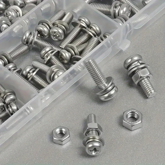 Assorted metal screws and nuts on a gray surface with a clear plastic container.