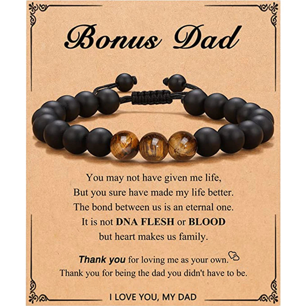 Black beaded bracelet with a message card for 'Bonus Dad' on a brown background