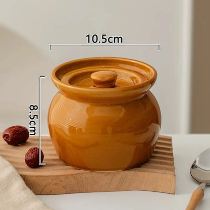 Brown ceramic jar with lid on a wooden board, with measurements indicated.
