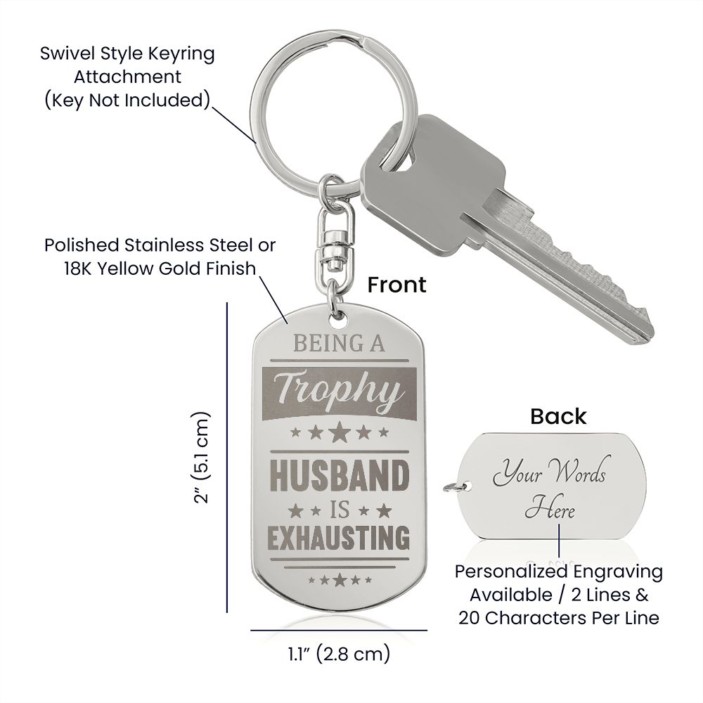 Being a trophy husband is exhausting  Create a unique keepsake with our Engraved Dog Tag Keychain. This high-quality stainless steel piece can be customized on the back in a scripted font, with 2 lines of text, up to 20 characters each.