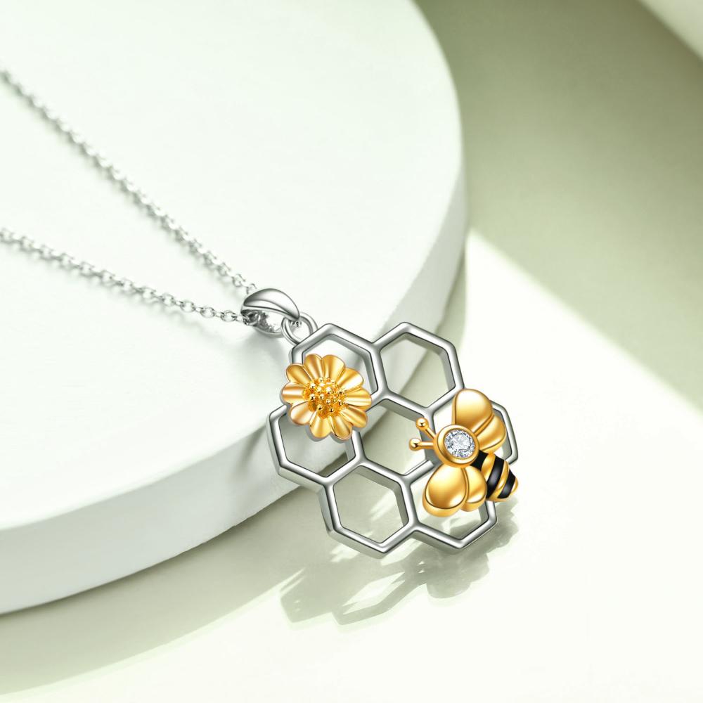 A rolo type chain that is 18 inches with an extra 2 inch extension. Gold and silver pendant with Zircon stone and comes in a delicate jewelry box. 