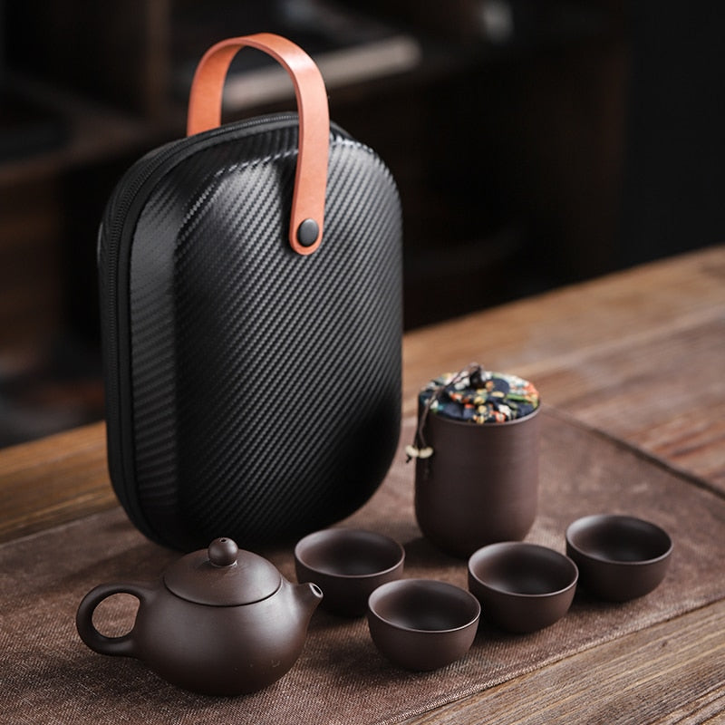 This Ceramic purple sand portable teapot set Features xishi teapot design, there is a filter in the spout of the teapot, the tea leaf and the tea water can be separated automatically, the beautiful details of this traditional  Chinese craftsmanship will bring beauty and elegance to your living room or office. suitable size, convenient to carry, safe and easy to store with portable storage bag.