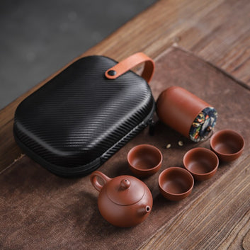 This Ceramic purple sand portable teapot set Features xishi teapot design, there is a filter in the spout of the teapot, the tea leaf and the tea water can be separated automatically, the beautiful details of this traditional  Chinese craftsmanship will bring beauty and elegance to your living room or office. suitable size, convenient to carry, safe and easy to store with portable storage bag.