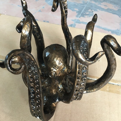 This Bronze Octopus is the perfect table topper for your next party. It holds your mugs for easy access, so party goers can dip into your punch at ease. The arms of this Octopus mug holder is perfect to hold small to medium size mugs and is a unique decoration to celebrate your unique style. 